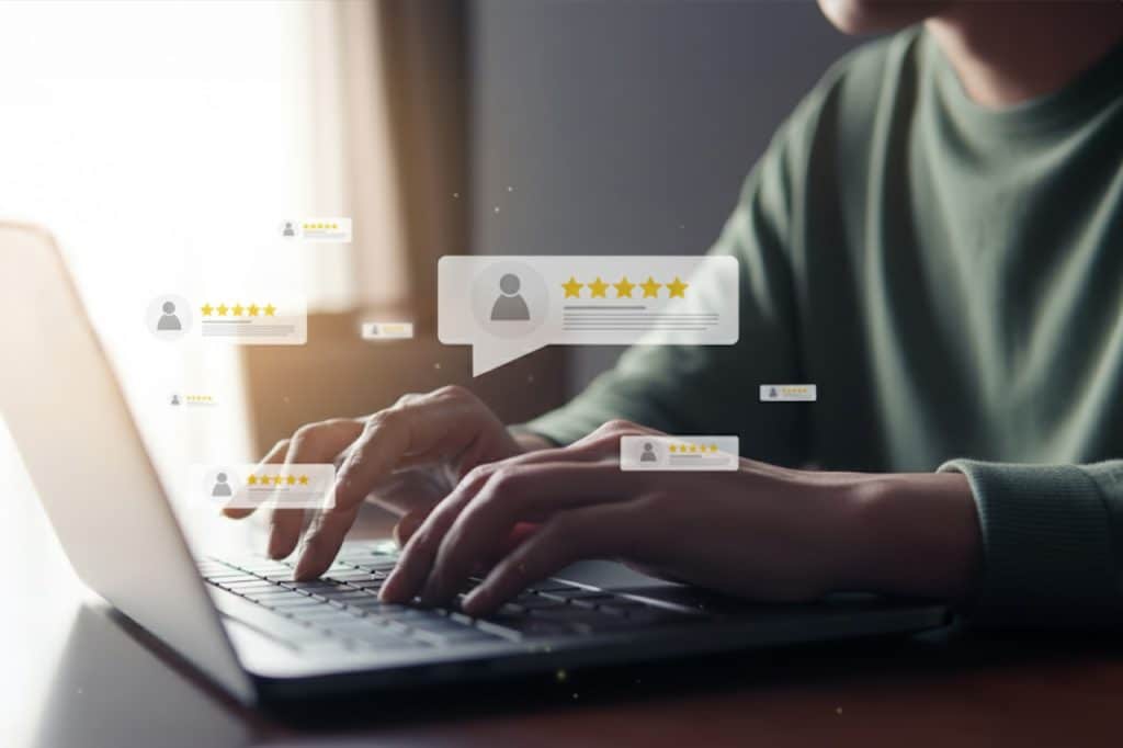 A person is typing on their laptop. Pop-ups are floating on the screen, displaying 5-star reviews of lawn and landscaping companies.