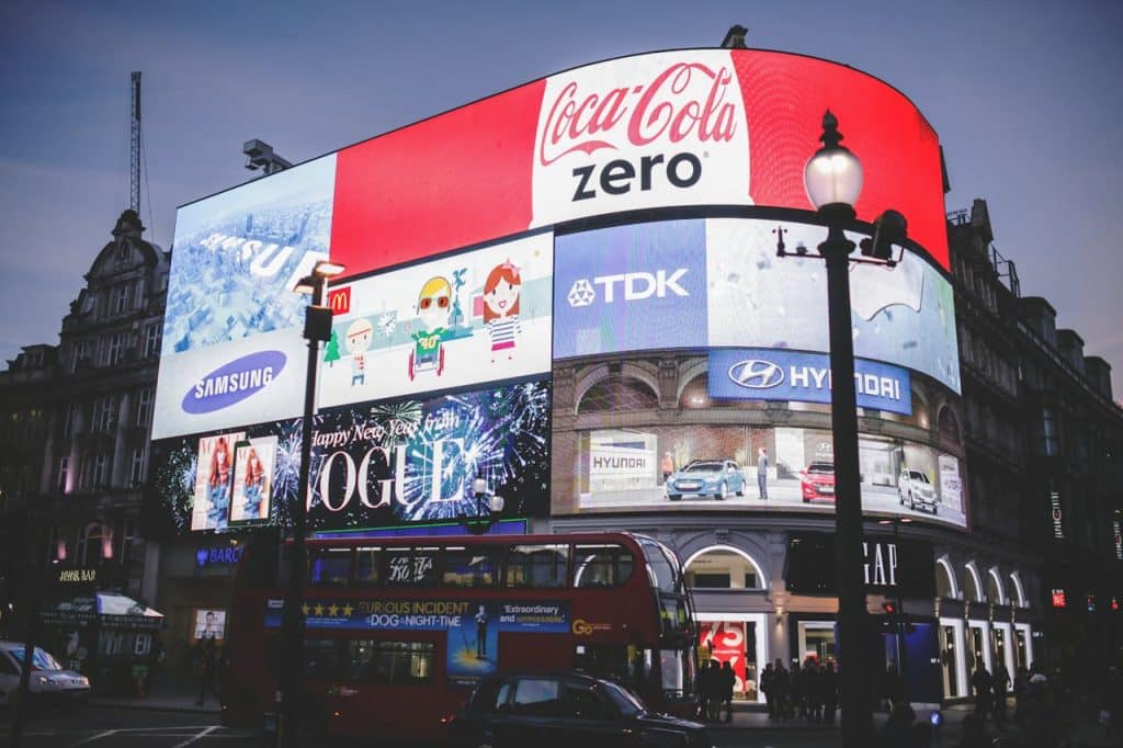 A Large digital billboard with multiple segrements displaying pieces of visual marketing about landscaping.
